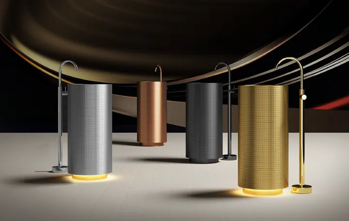 Gold and silver stainless steel pedestal basins displayed in a commercial bathroom setting